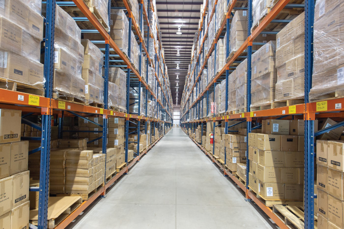 An aisle of warehouse racking stocked with RackSolutions products