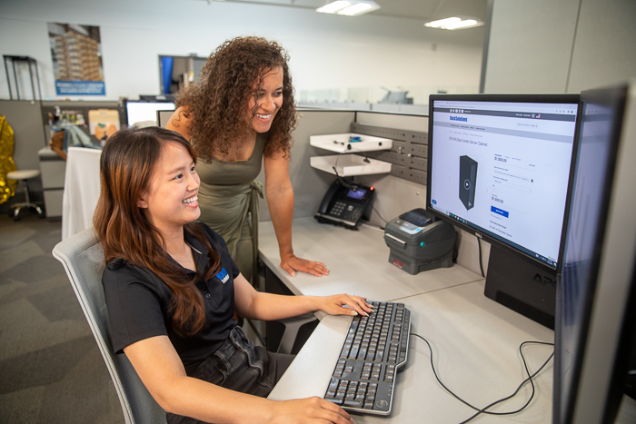 Two RackSolutions team members at a workstation