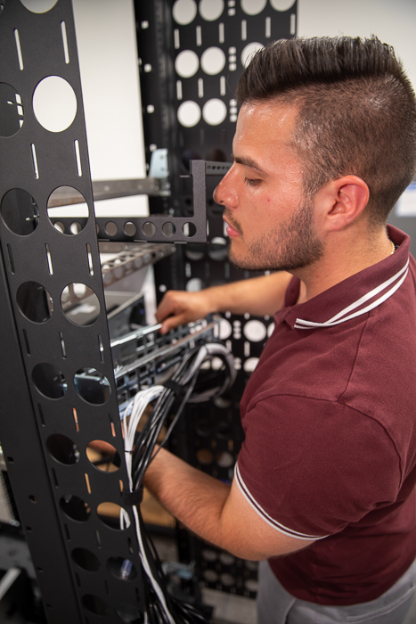 A RackSolutions team member cabling a server rack